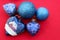 Set of blue Christmas tree decorations. blue christmas tree toys on red background with place for text. Glass toy heart. Shiny bal