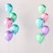 Set of blue, green, pink and purple glossy balloons on the stick on grey background. 3D render for birthday, party, wedding or pro