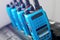 A set of blue walkie-talkies stand in a row. A device for transmitting stable radio communication over a distance.