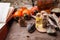 Set of bottles, assortment of dry healthy herbs, old books, stones and witch treatment on vintage wooden desk