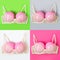 Set of bras with pink balloons on the backgrounds of different colors. Fun, conceptual photo, great big breasts