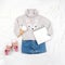 Set of casual child clothes, shoes, accessories and open notepad on white background. Fashion girl lookbook consept