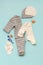 Set of children`s clothes for a newborn boy or girl on a blue background. Collection