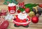 Set of Christmas decorations a plate in the form of Santa, a sock for gifts, a mug with marshmallows, a branch of spruce and gifts