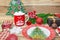 Set of Christmas decorations a plate in the form of Santa, a sock for gifts, a mug with marshmallows, a branch of spruce and gifts