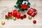 Set of Christmas decorative items red and gold shiny glossy sphere balls Candles Present gift box with silver ribbon bowtie Light