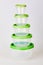 Set of circle transparent plastic food storage containers with green lids isolated