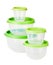 Set of circle transparent plastic food storage containers with green lids isolated