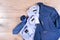 Set of classic mens clothes - blue suit, shirts, brown shoes, belt and tie on wooden background.