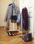 Set of clothers and shoes in flat hanging on rail, modern girl casual wardrobe concept
