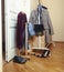 Set of clothers and shoes in flat hanging on rail, modern girl casual wardrobe concept