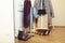 Set of clothers and shoes in flat hanging on rail, modern girl casual wardrobe concept