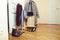 Set of clothers and shoes in flat hanging on rail, modern girl casual wardrobe concept