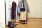 Set of clothers and shoes in flat hanging on rail, modern girl casual wardrobe concept