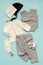 Set of clothes for newborns, a boy and girls on a blue background to choose from: jacket, trousers, body, hats and mittens for pro