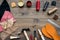 Set of cobbler tools on brown wooden desk background top view copyspace