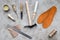 Set of cobbler tools on grey stone desk background top view