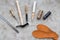 Set of cobbler tools on grey stone desk background top view