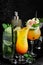 Set of colored alcoholic cocktails on a black stone background. Menu bar.