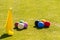 A set of colored croquet balls on the green lawn before the game