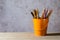 A set of colored pencils on a toy bucket in a beautiful brownish background