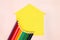 Set of Colored pencils on a yellow house