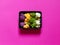 Set of colorful cauliflower violet, yellow, green and white boxed in a plastic recipient over a fucsia background