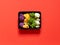 Set of colorful cauliflower violet, yellow, green and white boxed in a plastic recipient over a red background
