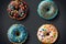 Set of colorful donuts isolated on black background