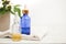 Set of colorful glass bottles with skin care products on white background with copy space. Face serums, acids and packages for