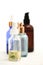 Set of colorful glass bottles with skin care products on white background with copy space. Face serums, acids and packages for