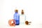 Set of colorful glass bottles with skin care products on white background with copy space. Face serums, acids and packages for