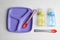 Set of colorful plastic dishware on wooden table, flat lay. Serving baby food