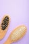 Set of comb and hairbrush on purple background with copy space. Vertical foto