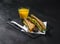 set consisting of two sandwiches malted bread with vintage cheddar cheese, pickles, red onion, tomato, lettuce, orange juice