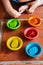 Set of containers shaped like wooden bowls, in several bright colors, montessori educational games