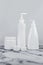 Set of cosmetic bottles, collection empty white bottles of cream with dispenser, shampoo or lotion on white background