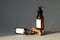 Set of cosmetic dark amber glass bottles mockup. Pump bottle hand soap and organic body spray. Natural SPA cosmetics packaging