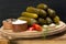 Set of cucumbers next to spices, pepper and salt, on a wooden table