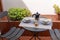 A set of decorated coffee cups with coffemaker, on a table set for breakfast, interior design on a balcony