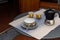 A set of decorated coffee cups with coffemaker, on a table set for breakfast, interior design on a balcony