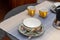 A set of decorated coffee cups with coffemaker, on a table set for breakfast, interior design on a balcony