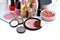 Set of decorative cosmetic: powder, lipsticks, brush, blush, eyeshadow, nail polish on a white background