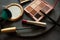 Set of decorative cosmetics, makeup tools and accessories on black slate background. Copy space. Flat lay. Top view. Skin care or