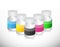 Set of different color medicine pill jars.