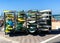 Set of different color surfboards in metal shelf  by sea. Favorite and popular recreation area for locals and tourists