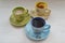 Set with different colorful cups of coffee espresso, cappuccino and tea