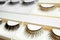 Set with different false eyelashes in packs as background