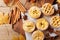 Set of different mini apple pies decorated sugar powder and cinnamon on wooden board top view. Autumn pastry dessert.