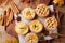 Set of different mini apple pies decorated sugar powder and cinnamon on wooden table top view. Autumn pastry dessert.